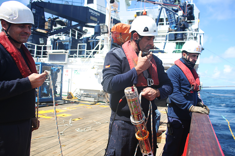 None of our science would have been possible without the help of our hardworking crew members! Here, Bosun Oscar Orizales Breijo prepares to deploy a MINION over the side of the aft deck. Photo by Marley Parker, @Woods Hole Oceanographic Institution